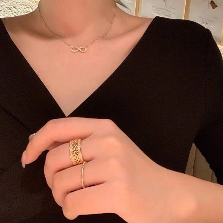 A woman wearing the gold infinity necklace, demonstrating its elegant and versatile style.