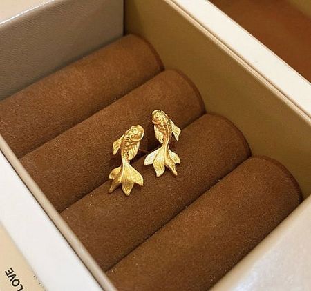 Unique gold-plated koi fish stud earrings, symbolizing luck and prosperity, presented in a jewelry box.