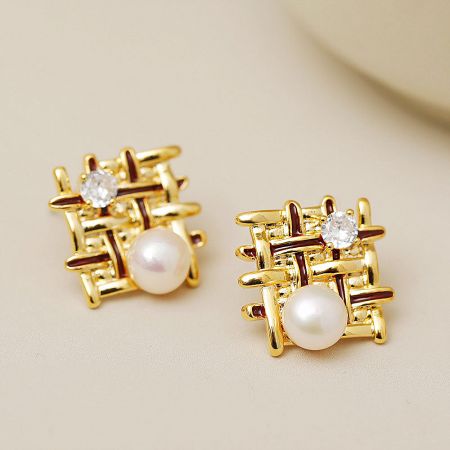 Another angle of the gold lattice earrings, highlighting the pearl and clear gemstone.