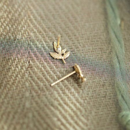 A detailed close-up of the 925 sterling silver gold maple leaf stud earrings, highlighting the intricate design.