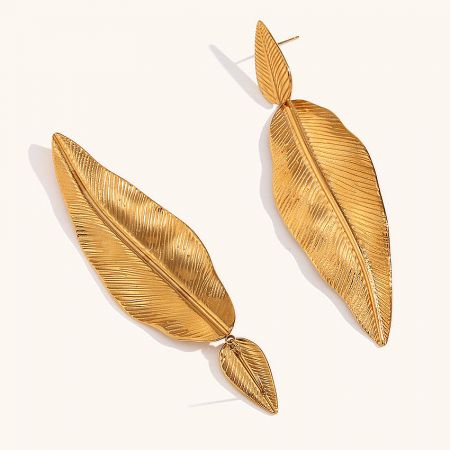 A pair of multi-leaf gold drop earrings against a white background.