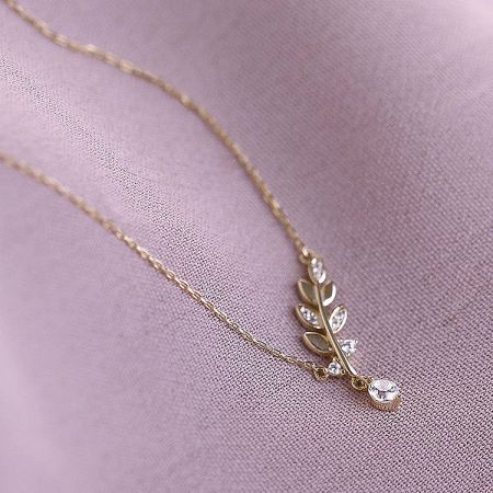 925 Sterling Silver Delicate Small CZ Leaf Necklace Set of 5 - A close-up of the 925 sterling silver delicate small CZ leaf necklace in a radiant gold finish, showcasing the sparkling cubic zirconia stones on the leaf pendant.