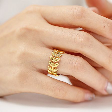 Stainless Steel Olive Branch Leaf Split Open Rings (Set of 5) - A close-up of a hand wearing the elegant stainless steel olive branch leaf ring with a beautiful gold finish, showcasing its adjustable open design.