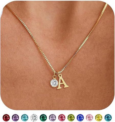 Detailed view of the gold 'A' initial pendant necklace with a clear birthstone.