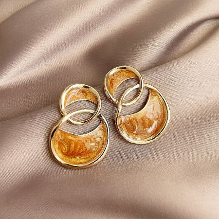 Front view of the gold-plated stud earrings, emphasizing the unique marbled effect on the interlocking circles.