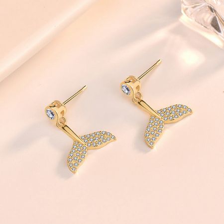 Detailed close-up of the gold mermaid tail stud earring, highlighting the intricate CZ gemstones.