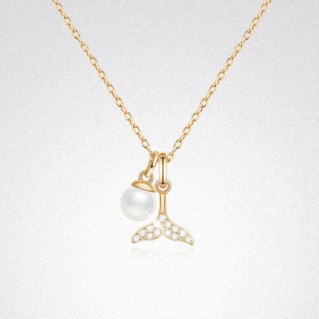 Detailed view of the gold mermaid tail pendant with a pearl seashell accent.
