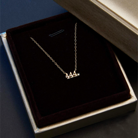 Gold-plated angel number 444 necklace displayed in a jewelry box.