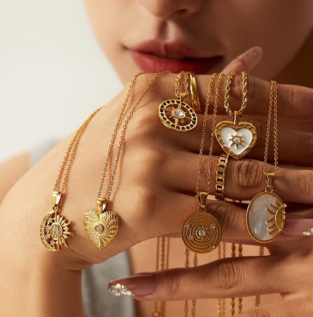 An assortment of 18K gold-plated stainless steel necklaces with various pendant designs.