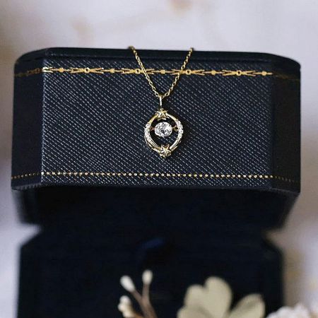 Detail of a celestial-themed pendant from the collection, featuring a crescent moon and star design.