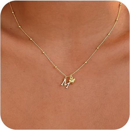The personalized heart necklace featuring the initial 'M', crafted from 14K gold plated brass.