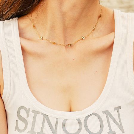 Model showcasing the layered look of the stainless steel coin disc charm choker necklace.