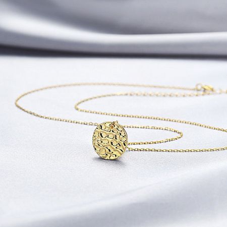 Angled shot highlighting the unique texture and shine of the spherical pendant.