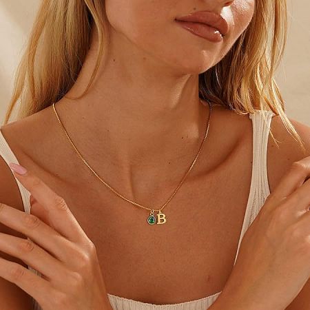 14K Gold-Plated Alphabet Birthstone Necklace - A close-up of the 14K gold-plated alphabet necklace with a 'B' initial and a vibrant green birthstone, worn elegantly on the collarbone.
