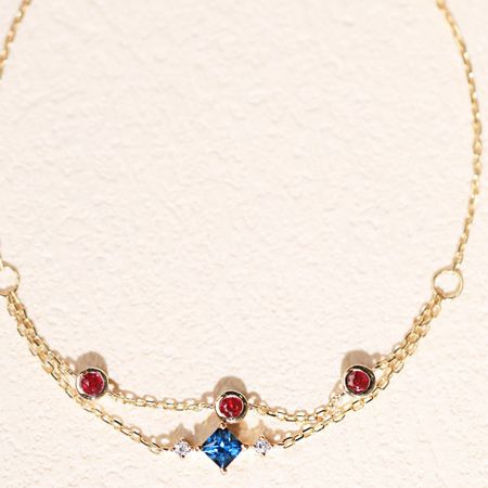 Another perspective of the colorful zircon chain bracelet, focusing on the centerpiece blue gemstone.