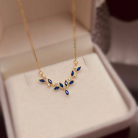 Detailed shot of the pendant, highlighting the combination of blue CZ and clear accent stones.