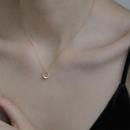 Model wearing the 925 sterling silver minimalist hollow pendant necklace in gold, showcasing its elegant look.