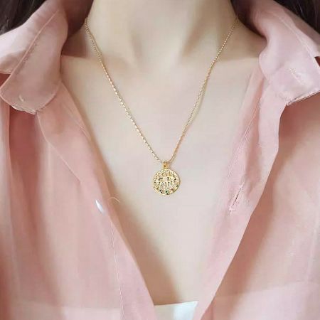 Product showcase of the circular evil eye pendant necklace against a clean background.
