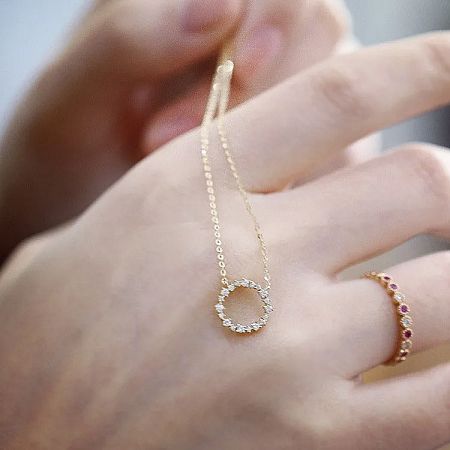 The zircon wreath pendant necklace displayed alongside a matching ring, showcasing a complete jewelry set.