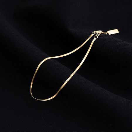 A model styling the minimalist silver anklet, perfect for summer and beachwear.