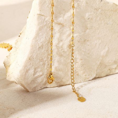 Detail of the necklace's secure gold clasp and extension chain.