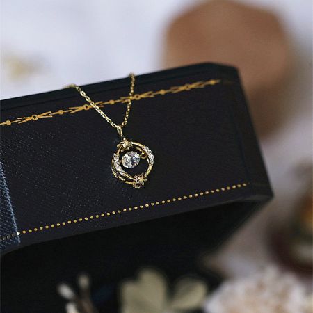 The dancing star necklace displayed in a black velvet jewelry box, highlighting its brilliant zircon.