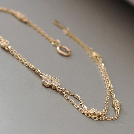 Full view of the 18K gold-plated double-layer bracelet against a neutral background.