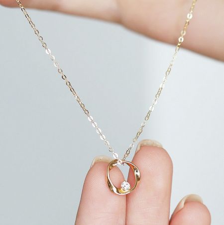Wholesale 925 Sterling Silver Mobius Ring & CZ Pendant Necklace (Set of 5) - Close-up of a 925 sterling silver Mobius ring pendant necklace with a central cubic zirconia stone, showcasing its elegant design.