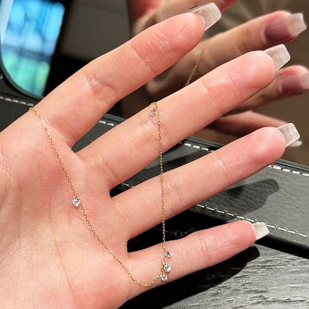 Detailed view of the 925 sterling silver necklace with cubic zirconia held in hand.