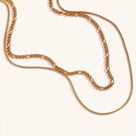 Detailed view of the stainless steel Figaro and snake chain necklace.