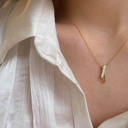 Detailed view of the gold 925 sterling silver cross necklace with cubic zirconia.