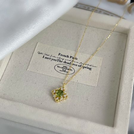 The elegant green zircon necklace presented in a wooden jewelry box, perfect for gifting.