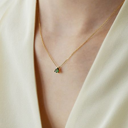 Front view of the minimalist emerald pendant necklace.