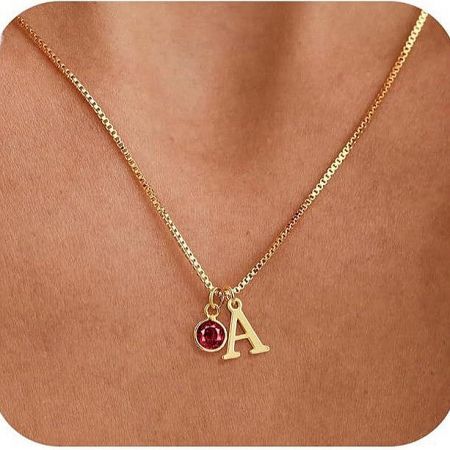 Close-up of the 'A' initial necklace with a striking red birthstone.