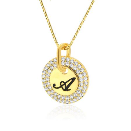 Detailed shot of the Initial A Letter Disc Pendant on a gold chain, showing the black epoxy and gemstone details.
