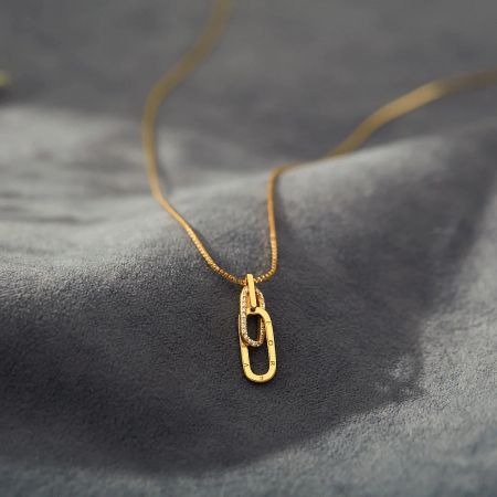The interlocking zircon pendant necklace in a luxurious gold finish.