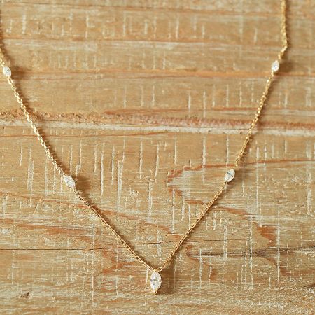 A clear view of the marquise-shaped pendant and the fine chain of the necklace.