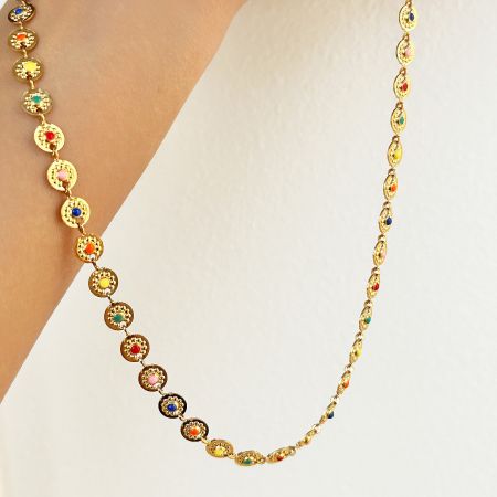 Detailed view of a gold waist chain with vibrant multicolored gemstones from the set.