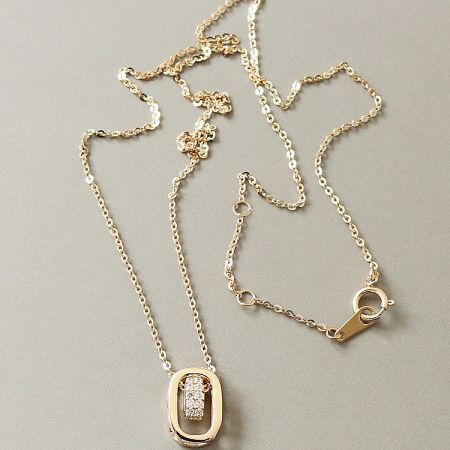 Another perspective of the gold-plated necklace with its intricate oval pendant design.