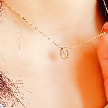 A view of the necklace on a display, highlighting its shine and appeal.