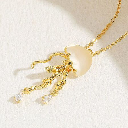 Another unique design in the ocean-themed collection, a gold necklace with a pearl and gemstone pendant.