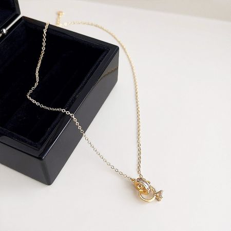 A different angle of the interlocking circle necklace next to its elegant presentation box.