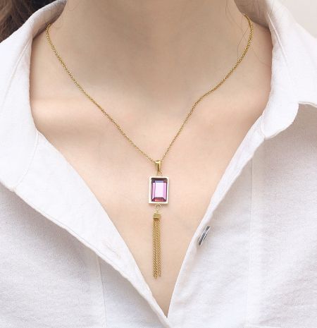 Alternative color option showing a gold necklace with a pink gemstone pendant.