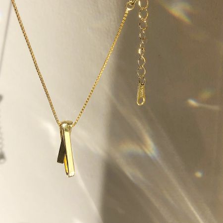 Side view showcasing the craftsmanship of the gold pave CZ pendant.