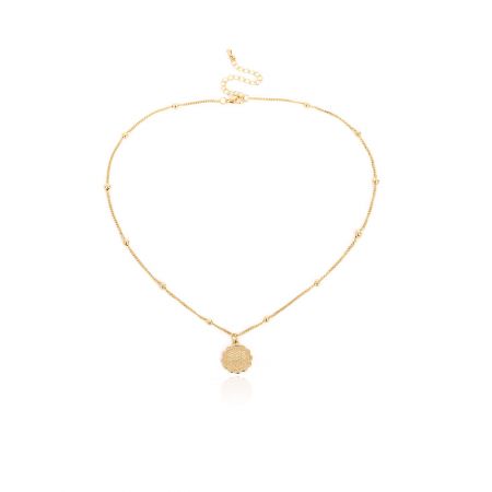 A gold zodiac necklace with a round pendant shown from a different angle.
