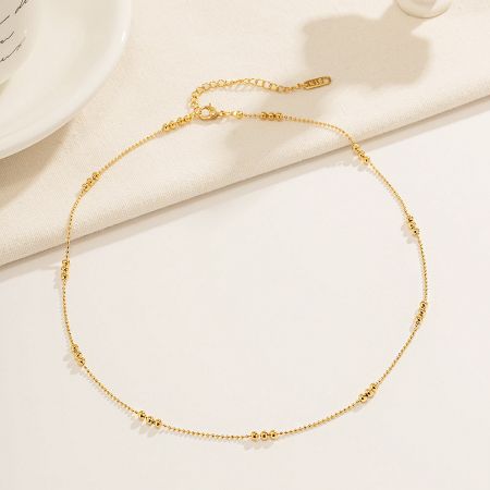 Close-up of the K18 gold beaded necklace, highlighting its fine craftsmanship.
