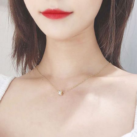 Minimalist gold necklace with a small, elegant pendant from the choker set.