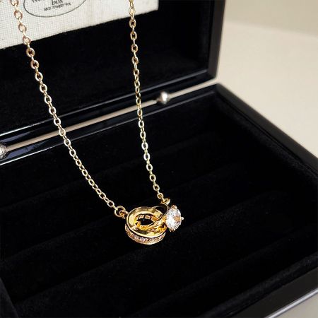 The gold-plated zircon necklace presented beautifully in a black velvet-lined jewelry box.