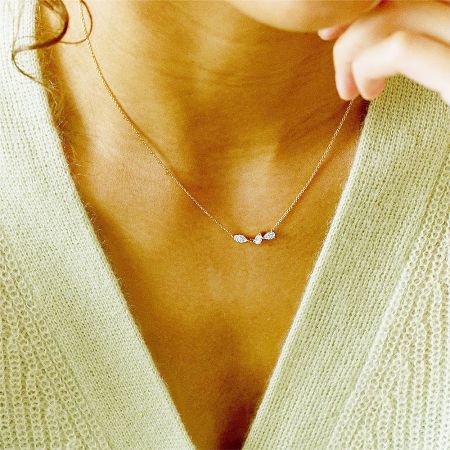 Model wearing the gold geometric cluster zircon necklace, demonstrating its elegant drape and style.