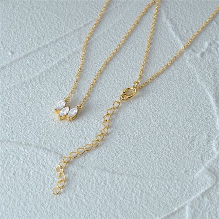 The three-stone marquise pendant shown on a delicate gold chain.